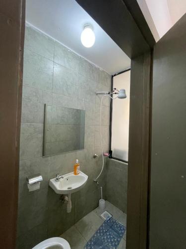 a bathroom with a sink and a toilet and a mirror at Destinyspaces in Nairobi