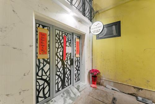 a building with a door with a vase of flowers on it at Train Street Lux Homestay in Hanoi