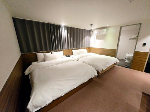 Postel nebo postele na pokoji v ubytování Jamsil Noblestay Hotel