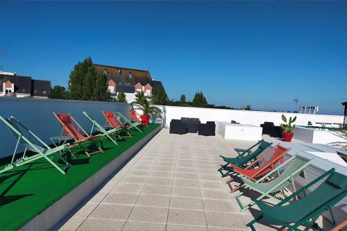 a group of chairs sitting on a roof at Adonis La Baule in La Baule