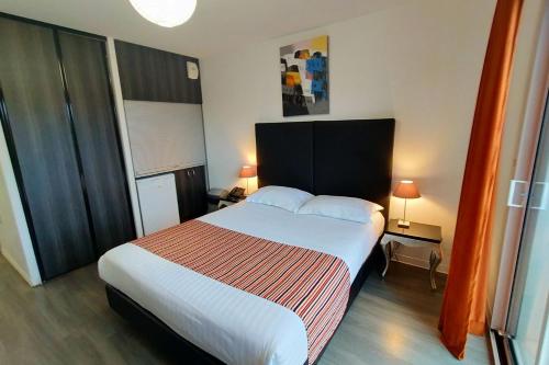 a bedroom with a large bed in a room at Adonis La Baule in La Baule