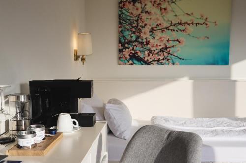 a room with a counter with a coffee maker on a table at Das Parkhotel in Bad Wörishofen