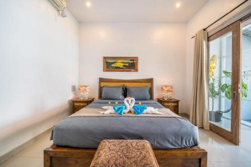 En eller flere senge i et værelse på Pondok Putri Bali