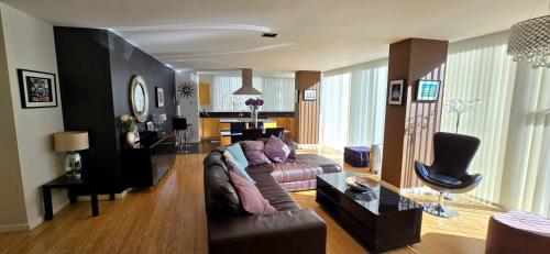 a living room with a couch and a table at Luxury Apartment Best location in Liverpool city center in Liverpool