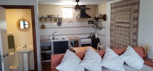 a living room with a couch with white pillows at House in Rodalquilar valley in Rodalquilar