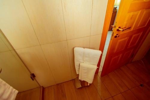 a small room with a towel hanging on the wall at Trois Ore Residences & Green Earth Bistro in Ibadan