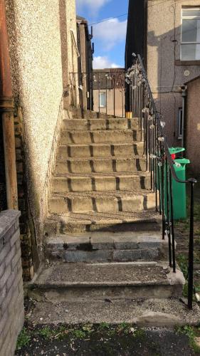 a set of concrete stairs next to a building at Beach & City Access - 2 Floors, Full Kitchen, Free Parking in Methil