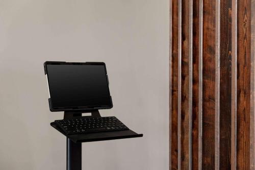 a laptop computer sitting on a stand on a wall at Days Inn by Wyndham Emporia in Emporia