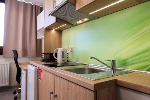 a kitchen with a sink and a microwave at Dom Studencki Arka in Wrocław