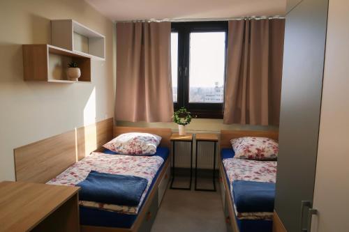 Postel nebo postele na pokoji v ubytování Dom Studencki Arka