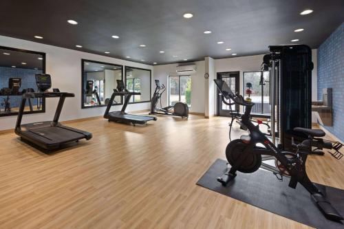a gym with several treadmills and ellipticals in a room at La Quinta Inn & Suites by Wyndham Meridian in Meridian