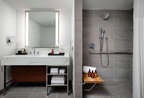 a bathroom with a sink and a shower at Hotel Alpenrock Breckenridge, Curio Collection by Hilton in Breckenridge
