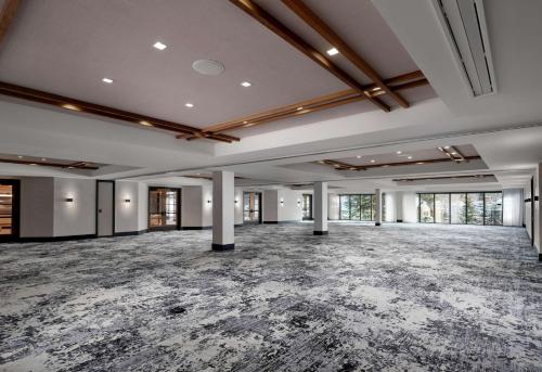 an empty ballroom with a large room with windows at Hotel Alpenrock Breckenridge, Curio Collection by Hilton in Breckenridge