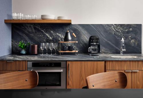 a kitchen with a counter top with wine glasses at Hotel Alpenrock Breckenridge, Curio Collection by Hilton in Breckenridge