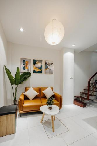 a living room with a couch and a table at 4Brs 20mToHoanKiemLake Central Private OldQuarter in Hanoi