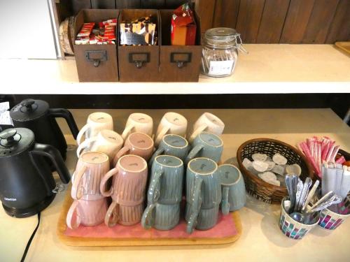a group of different colored cups on a counter at Pension B,B, Dylan - Vacation STAY 30973v in Otsu