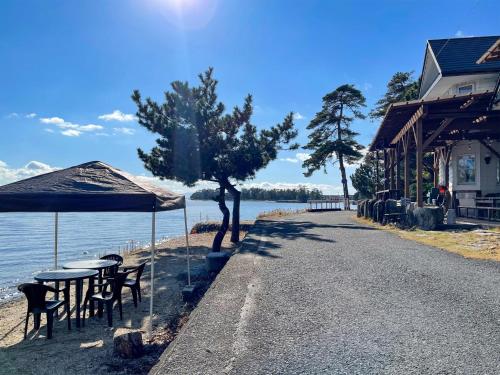 a street with tables and chairs next to the water at Pension B,B, Dylan - Vacation STAY 30973v in Otsu