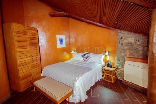 a bedroom with a white bed in a room at Trois Ore Residences & Green Earth Bistro in Ibadan