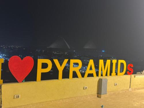 a sign that says i love pyramids with a red heart at ROFY VIP Apartment in Cairo