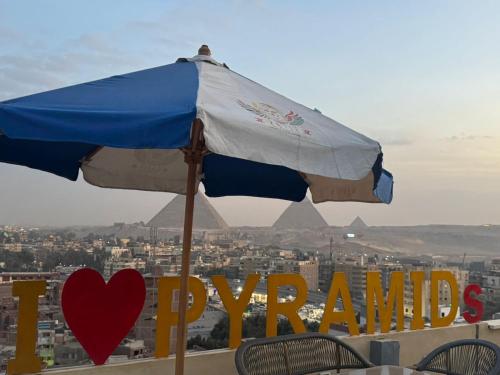 a blue and white umbrella sitting on top of a city at ROFY VIP Apartment in Cairo