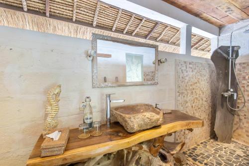 a bathroom with a sink and a mirror at Megalan Villa Balangan in Badung