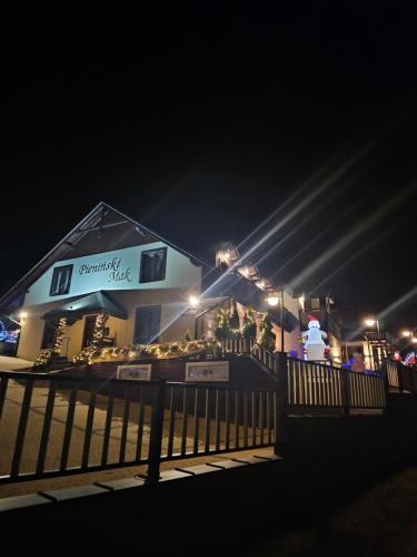 a building with a fence in front of it at night at Pieninski Mak. in Szczawnica