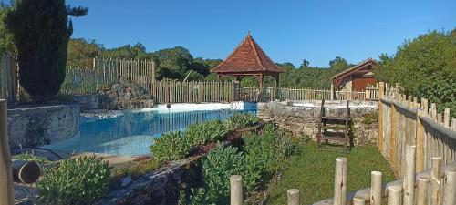 a backyard with a pool and a gazebo at Tente Perchée Kenya MAS DE BOUZOU in Grèzes