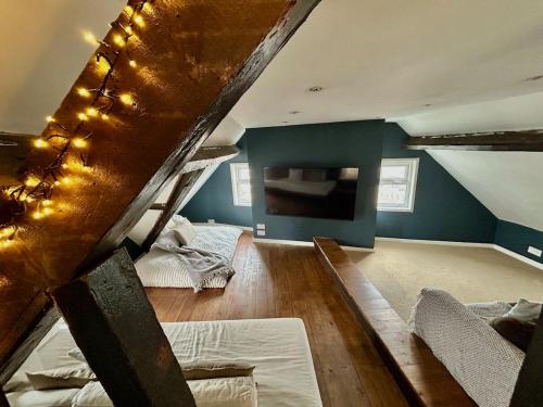a attic room with two bunk beds and a staircase at Henwick Loft in Henwick