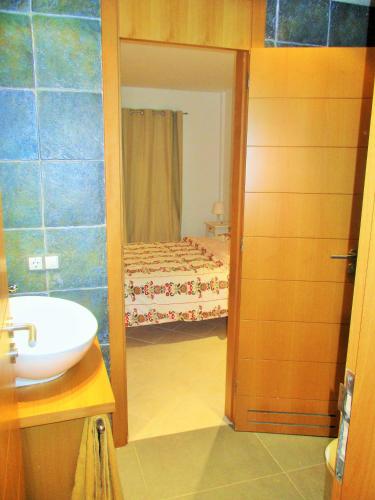 a bathroom with a sink and a bedroom with a bed at Apartment luxury complex near the sea in Adeje