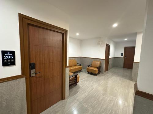 a hospital hallway with a door and a waiting room at Bloomax Residency in Malappuram