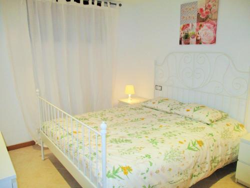 a bedroom with a white bed with a white crib at Apartment luxury complex near the sea in Adeje