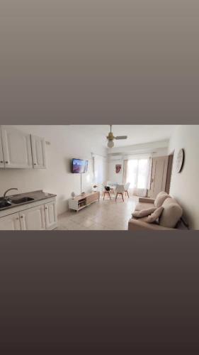 a living room with a couch and a tv at Petite Etoile in SantʼAgata di Militello