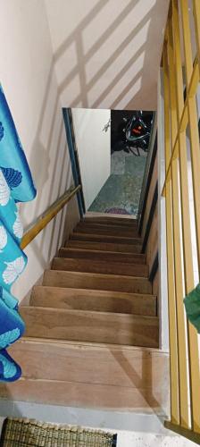 a stairway with wooden stairs in a house at Swarang homestye in Nandgaon