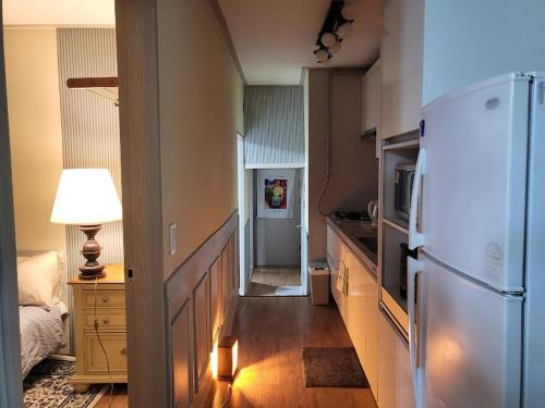 a kitchen with a white refrigerator in a room at Casa de Minrak in Busan