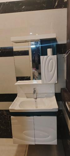 a bathroom with a white sink and a mirror at Seabreeze Marari in Alleppey