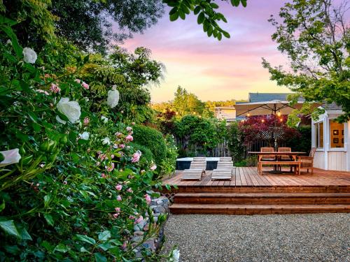 a wooden deck with a bench and a table at Spacious Oasis Hot Tub Backyard Garden 3BR/2BA in Sonoma