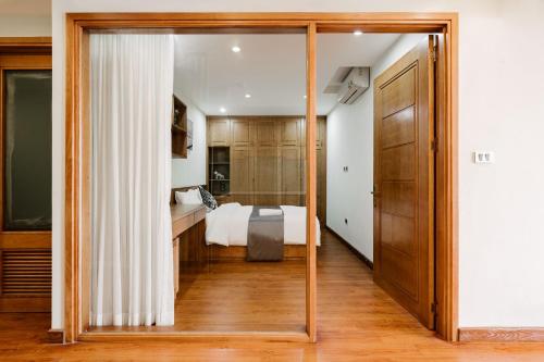 a bedroom with a bed and a large mirror at D Le Roi Soleil Premium Suites in Hanoi