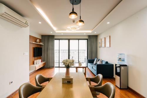 a living room with a table and chairs at D Le Roi Soleil Premium Suites in Hanoi