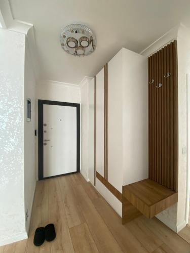 a room with a hallway with a door and a chandelier at Apartment for holidays in Ferizaj