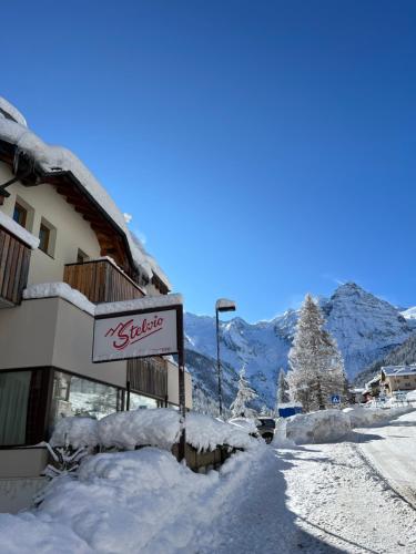 a building with a sign in the snow at Stelvio Residence in Trafoi