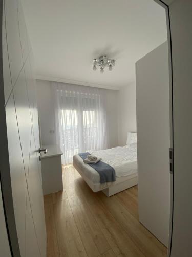 a bedroom with a bed and a mirror at Apartment for holidays in Ferizaj