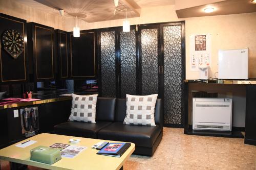 a living room with a couch and a table at Win Village in Sasebo