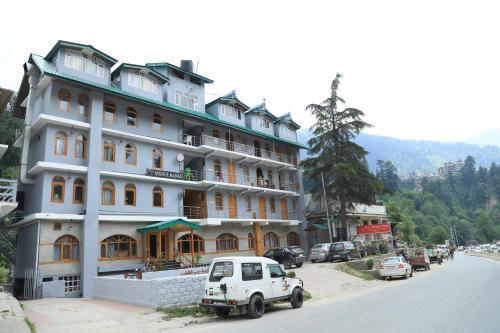 a white car parked in front of a building at The Avenue River Side Hotel - Near Volvo Bus Stand Manali in Manāli