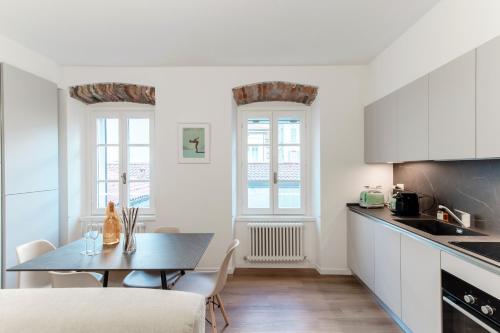 a kitchen with a table and a dining room at Sunflower Apartment -The House Of Travelers in Como