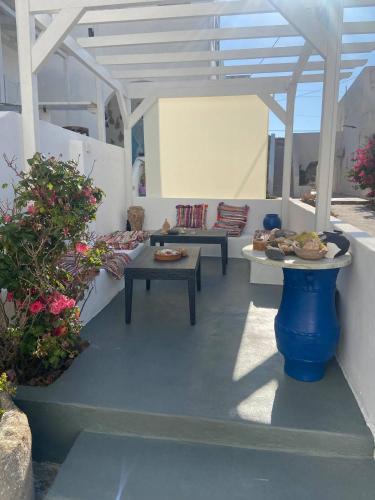 a patio with two tables and a table with plates of food at Casa Filareti-Twin studio in Ios Chora