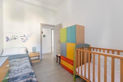 a bedroom with a bunk bed and a crib at Cappuccini apartment lower in Oristano