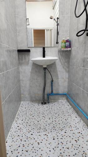a bathroom with a sink and a tiled floor at La Locanda in Bangkok