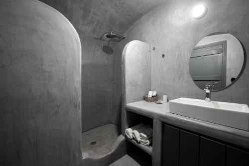 a bathroom with a sink and a mirror at Lotza Studios in Oia