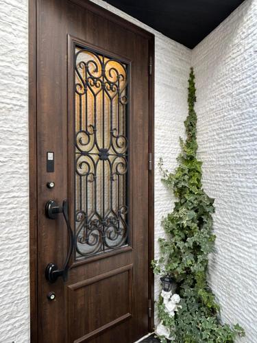 a door to a house with a plant next to it at Premium Sirayama in Saga