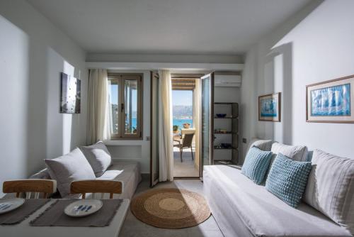 a living room with a couch and a table at Skajado Holiday Apartments in Stalida